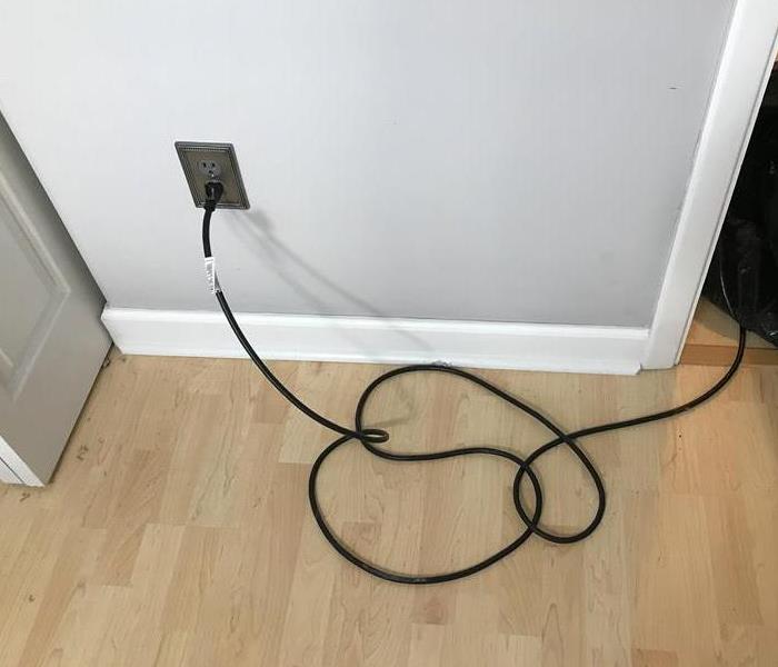 a grey wall with an outlet