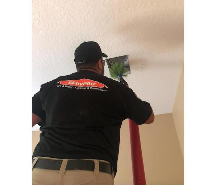 Worker cleaning air duct 